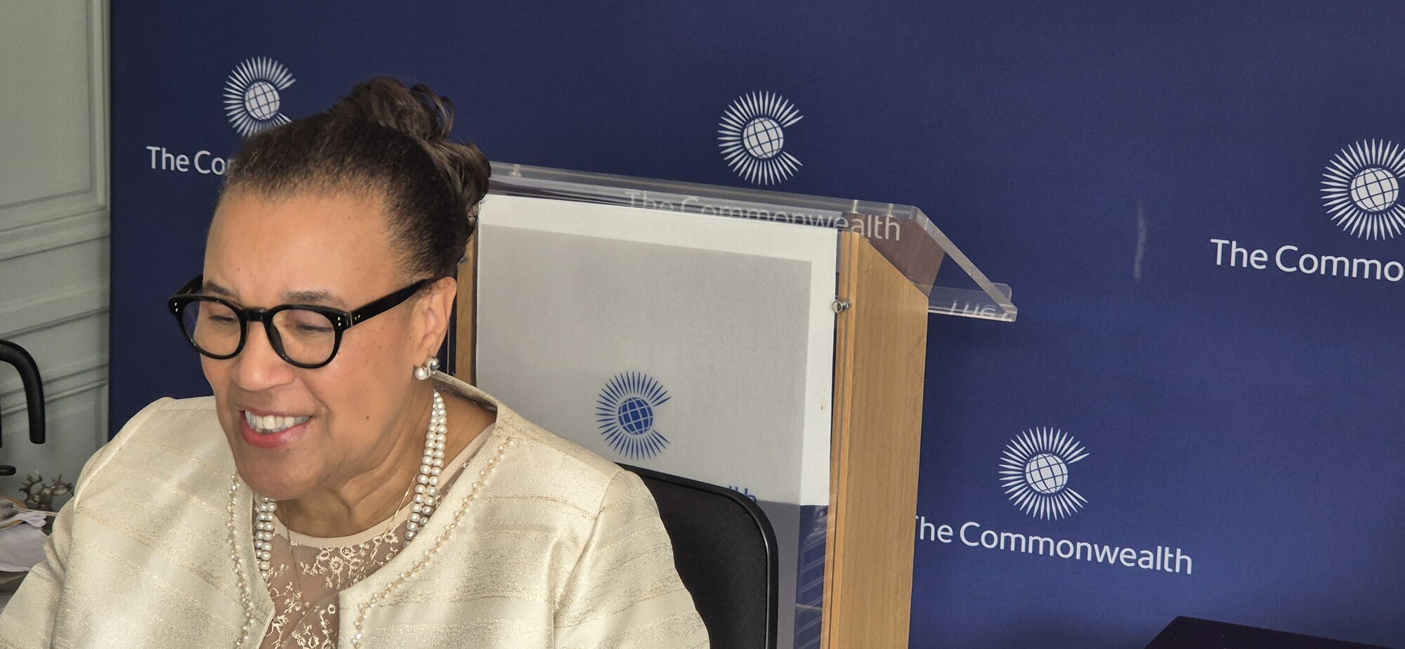SG delivering a speech from her home office