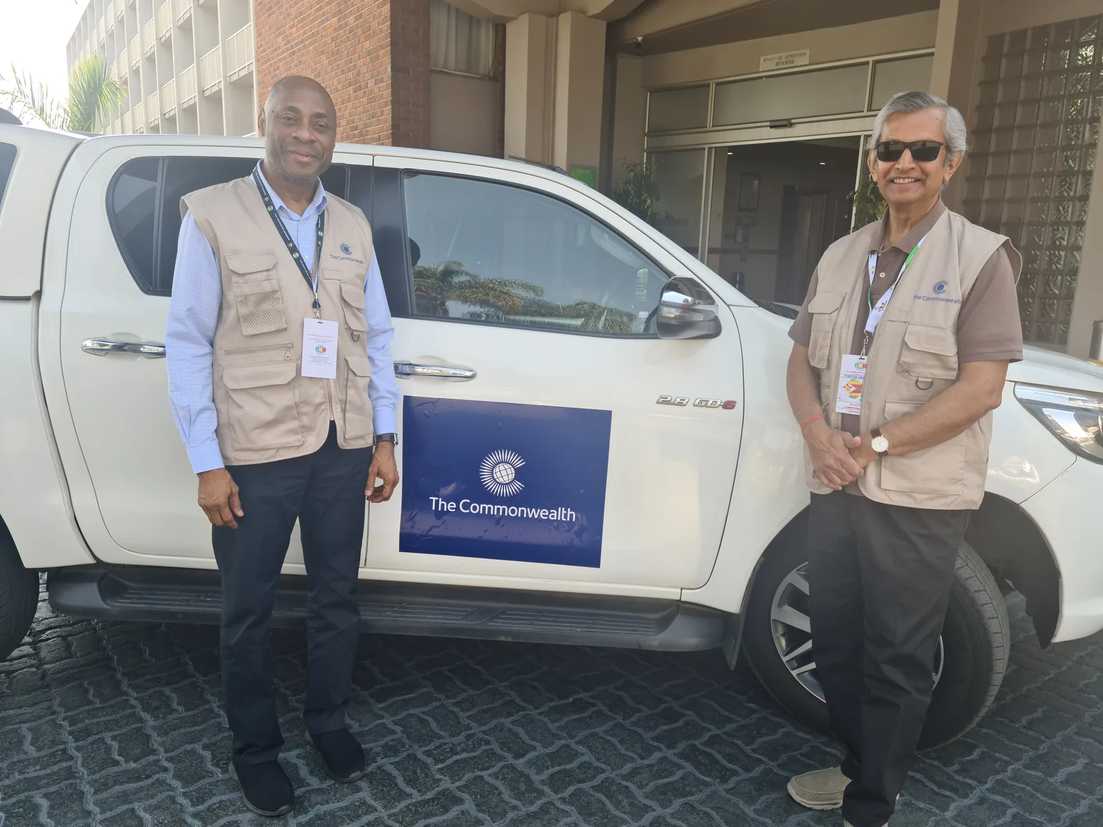 With a fellow observer beside a Commonwealth election observer vehicle